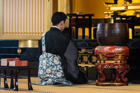 Buddhist monk praying in temple in Tokyoのeditorial素材