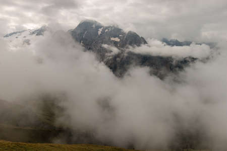 mountain range in Dolomites obscured by cloudsの写真素材