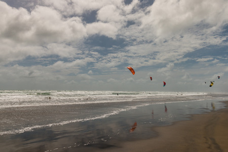 kite surfers on beach in New Zealandの写真素材