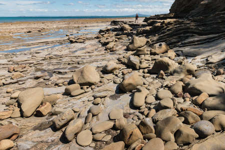 boulders on New Zealand coast at low tideの写真素材
