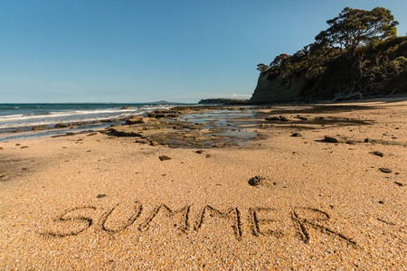 New Zealand beach with word Summer written in sandの写真素材