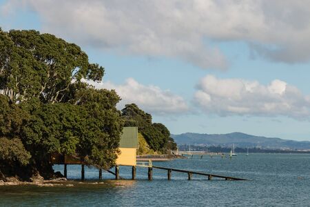 shed on wooden jetty on New Zealand coastの写真素材