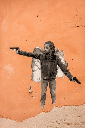 graffiti of child gangster on orange wallのeditorial素材
