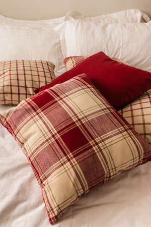 tartan pillows on bed in hotel roomの写真素材