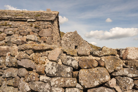 closeup of dry stone wall and houses