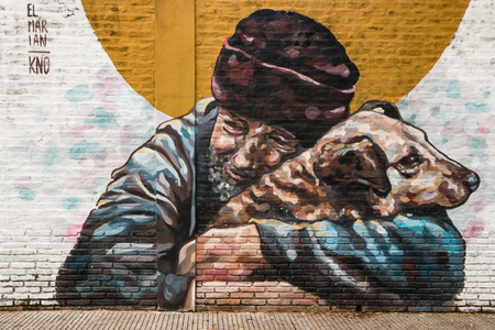 graffiti of homeless man holding dogのeditorial素材