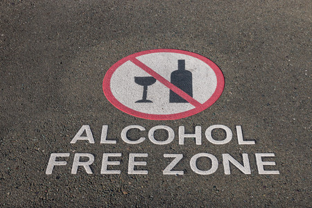 closeup of alcohol free zone sign on pavementの写真素材