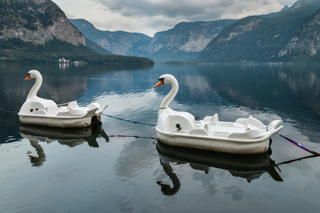 swan paddle boats  moored at  Hallstatt lake in Austriaの写真素材