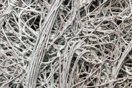 closeup of tangled strands of silver wire on black backgroundの写真素材