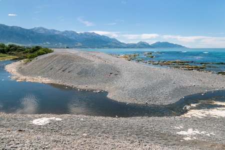 Kaikoura coastline with stream and pebble beach, South Island, New Zealandの写真素材