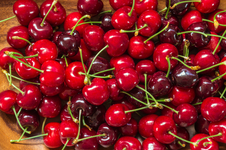 closeup of ripe red cherries in wooden bowlの写真素材