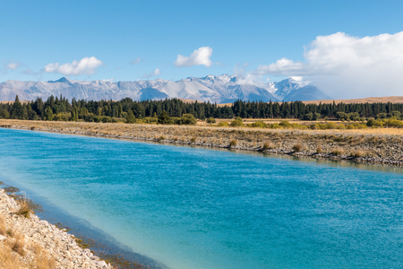 Tekapo canal in Mackenzie Country with Southern Alps in background, South Island, New Zealandの写真素材