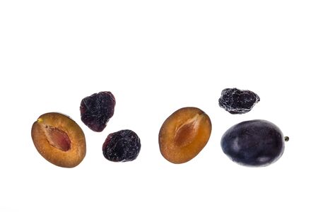 closeup of prune plums with dried prunes on white background with copy space aboveの写真素材