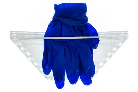 pair of blue surgical gloves with N95 face mask isolated on white background - protective equipment against COVID-19の写真素材
