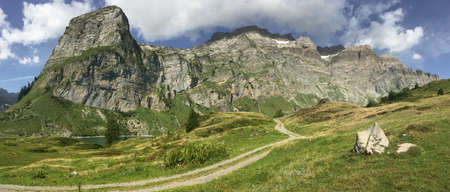 panorama of mountain range above Oberblegisee lake in Braunwald, Glarus Canton, Switzerlandの写真素材