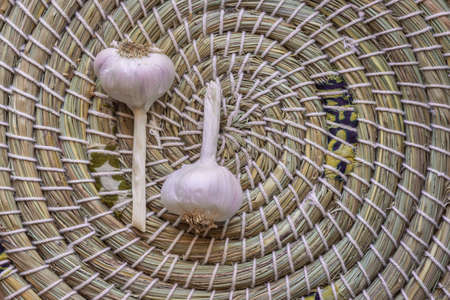 closeup of dry garlic bulbs in woven basket with copy space on rightの写真素材