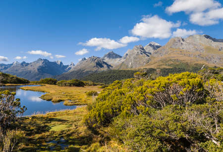 alpine lake at Key Summit Track in Fiordland National Park, South Island, New Zealand with blue sky and copy spaceの写真素材