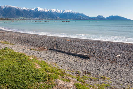 empty pebble beach in Kaikoura with Kaikoura Seaward Ranges in distance, South Island, New Zealandの写真素材