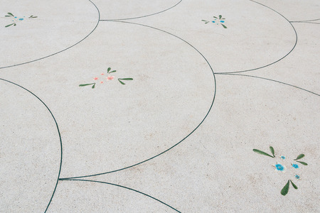 Concrete floor with small stones and decorating by flower pattern. background.の写真素材