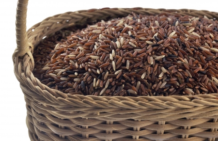 close up of brown rice in the bamboo basket ,isolated on white backgroundの写真素材