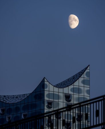 scenic view to elbphilharmony with huge moon visible close to modern building hamburg germany