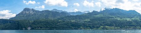 panoramic view into the mountains on a boat cruise on lake lucerne end of spring switzerlandの写真素材