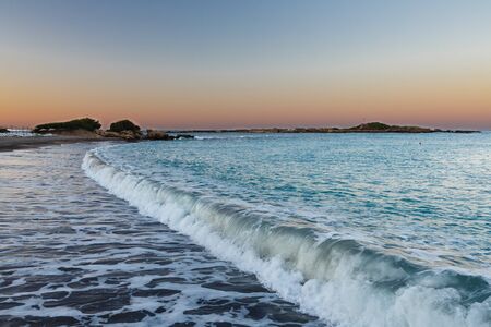 Sea wave running on a beach early in the morningの写真素材