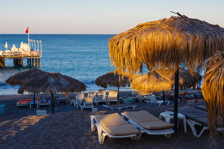 Early morning on a sea beach shined by rising sunの写真素材