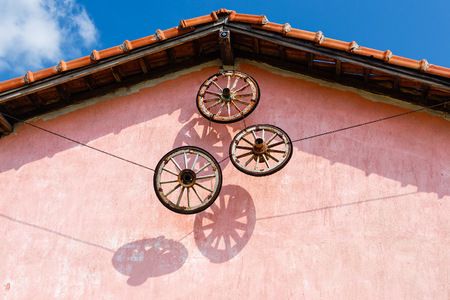 Wheels from a cart used as decoration of the farmer houseの写真素材