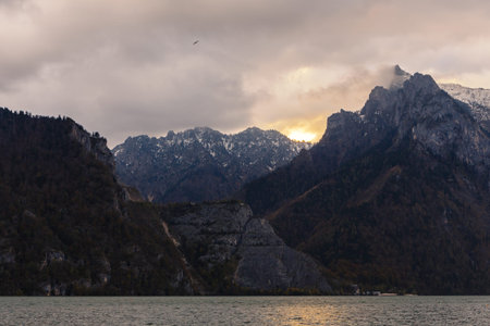 Sunrise over  rocky mountains overclosed by cloudsの写真素材