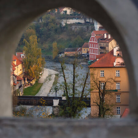 View of the city of Cesky Krumlov and Vltava river through a castle windowのeditorial素材