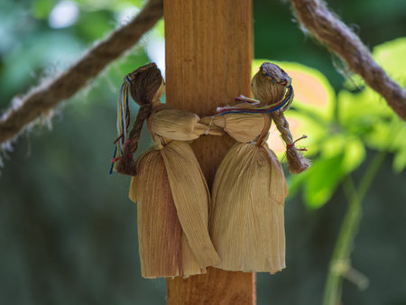 Straw dolls decorating a wooden arbor in gardenの写真素材