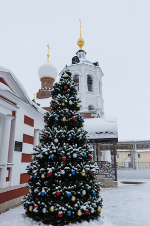 Decorated fir-tree set up near by church on the eve of orthodox Christmasの写真素材