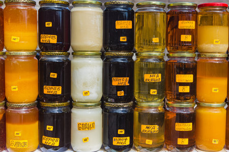 Sale of different varieties of natural honey in glass jars