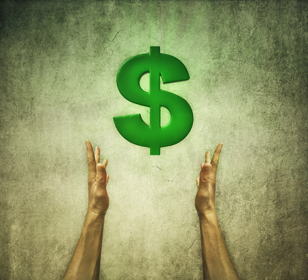 Closeup of two human hands holding a green dollar sign. Financial conceptの写真素材