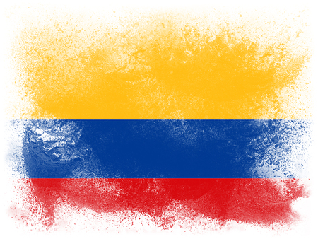 Powder paint exploding in colors of Columbia flag isolated on white background. Abstract particles explosion of colorful dust.の写真素材