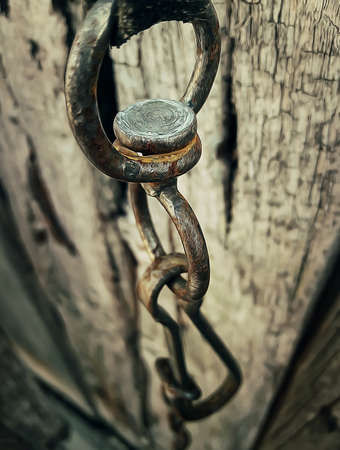 Illustration of a rusty iron chain on wooden texture backgroundの写真素材