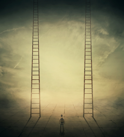 Surrealistic concept as a man standing in a foggy street looking at two stairways, thinking which to climb, choosing the correct way up. Different life opportunities, best choice for career development.の写真素材