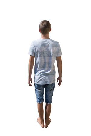 Rear view full length portrait of casual young man isolated over white background.の写真素材