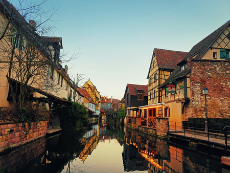 Autumn evening in colorful romantic city Colmar, France, Alsace. Traditional houses near the river. Medieval home facade, historic town. Beautiful idyllic architecture.の写真素材