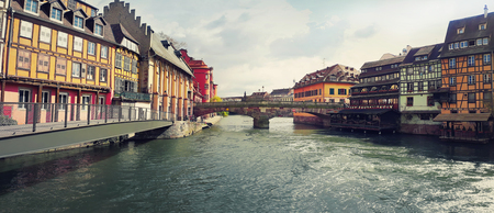 Amazing panorama of colorful romantic city Strasbourg, France, Alsace. Traditional houses on the both sides of the river and an old bridge crossing the canal. Historic town, beautiful architecture.の写真素材