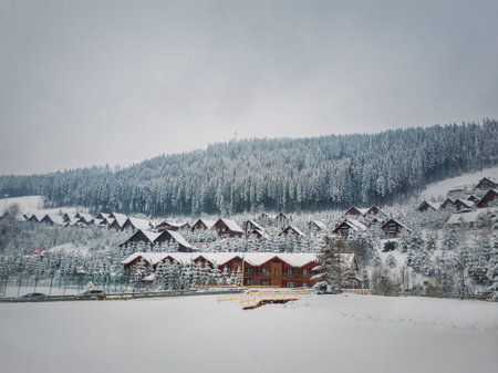 Bukovel ski resort, town cabin hotels covered with snow in a cold winter day. Holiday and vacation...