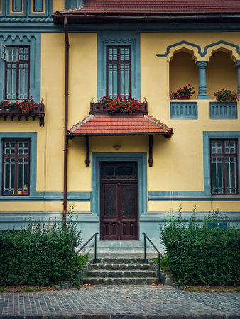 Colorful house facade, vintage style with retro porch and awning. Traditional european building exterior, front view at entrance doorの写真素材