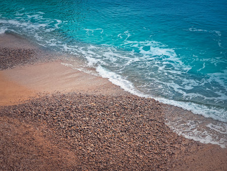 Blue ocean waves hits the shoreline. Beautiful texture of sea water and sandy beachの写真素材