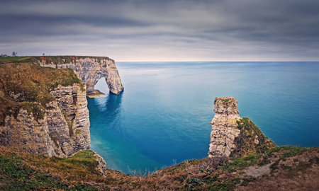 Beautiful view to the Porte d'Aval natural arch at Etretat famous cliffs in Normandy, Franceの写真素材