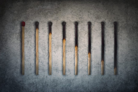 Match sticks burnt at different stages arranged in shape of a decreasing graph or chart. Business...