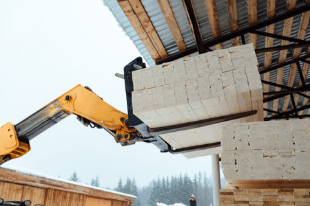 forklift truck with planks, delivery of wood to the warehouse, loading a large number of wooden planks with the help of industrial transportの写真素材