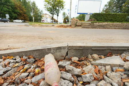 poorly executed road repairs. replacing the old curb stone with a new oneの写真素材