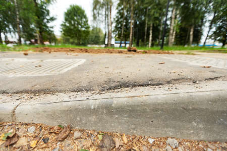 poorly executed road repairs. replacing the old curb stone with a new oneの写真素材