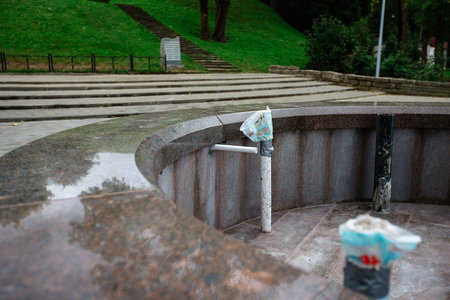 Fountain for drinking water in the park on a rainy day.の写真素材